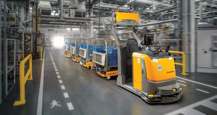 Automated Tow Tractor pulling carts in warehouse